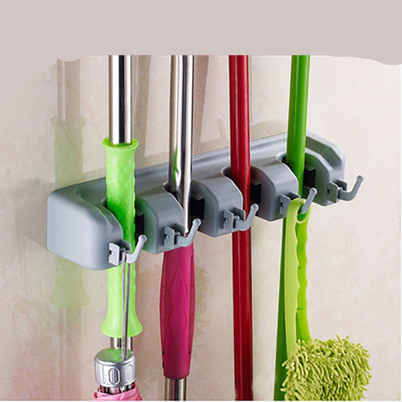 Multifunctional broom storage rack